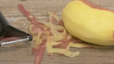 The process of peeling a Banana using a Vegetable Peeler can be quite Stock Footage 280603169