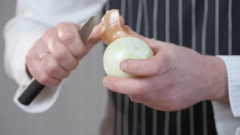 The process of peeling an onion. Mans hands peeling an onion. Slow motion video. Stock Footage 233009681