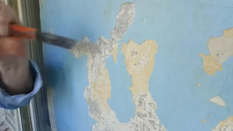 Process of peeling walls from old paint Stock Footage 142330124