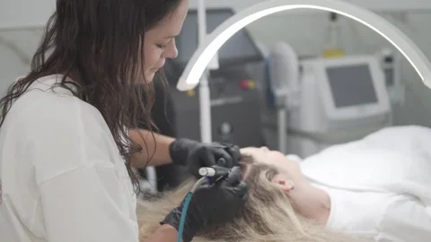 The process of performing the HydraFacial Keravive procedure using the Stock Footage 311106477