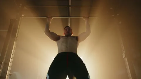 Process of performing pull ups on bar by fit man with bare muscular torso Stock Footage 240076885
