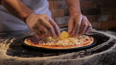 The process of pizza cooking, applying mozzarella on it. Chef is wearing gloves Video stock 132004806