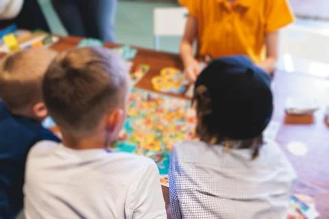 Process of playing board game and having fun with friends and family indoor.. Stock Photos