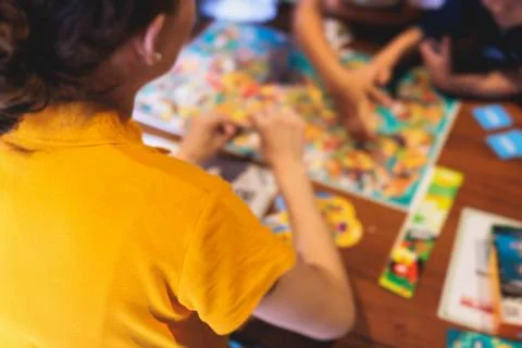 Process of playing board game and having fun with friends and family indoor.. Stock Photos