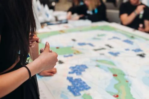 Process of playing tabletop board game on the table, fun with friends and f.. Fotos de archivo