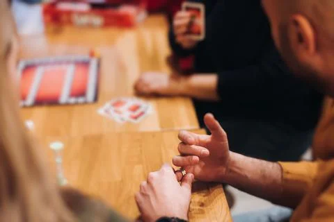 Process of playing tabletop board game on the table, fun with friends and f.. Stock Photos