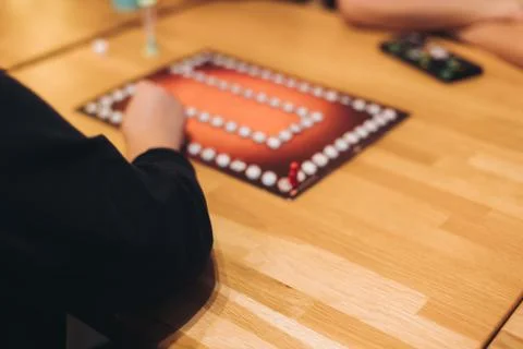 Process of playing tabletop board game on the table, fun with friends and f.. Stock Photos