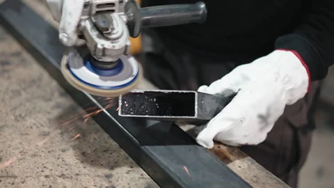 Process of polishing cut metal bars angles with handheld electric angle grinder Stock-Footage 266170376