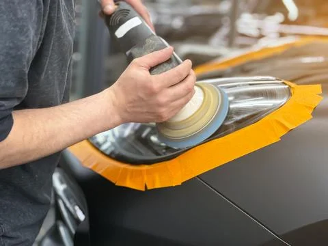 Process polishing of the front car headlights. Stock Photos