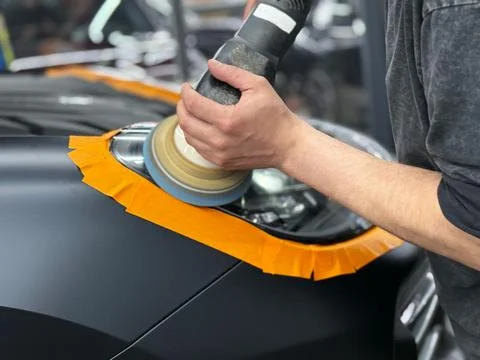 Process polishing of the front car headlights. Stock Photos