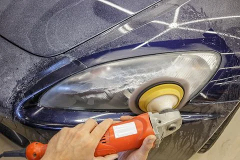 The process of polishing the headlights. Stock Photos