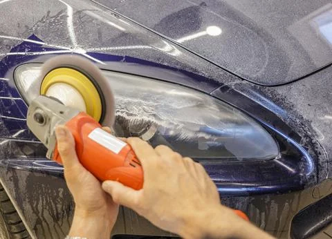 The process of polishing the headlights. Stock Photos