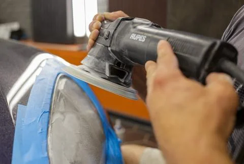The process of polishing the headlights. Stock Photos