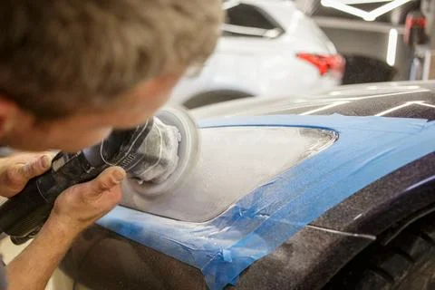 The process of polishing the headlights. Stock Photos