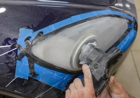 The process of polishing the headlights. Stock Photos