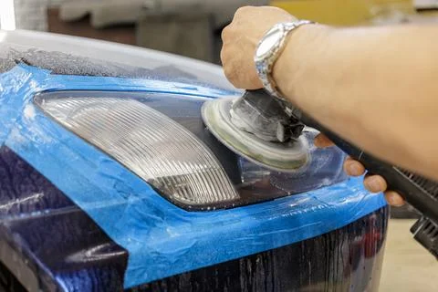 The process of polishing the headlights. Stock Photos