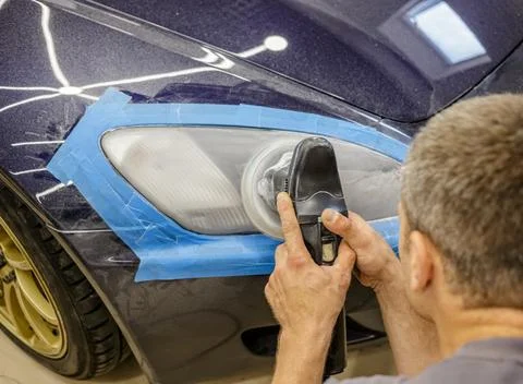 The process of polishing the headlights. Stock Photos