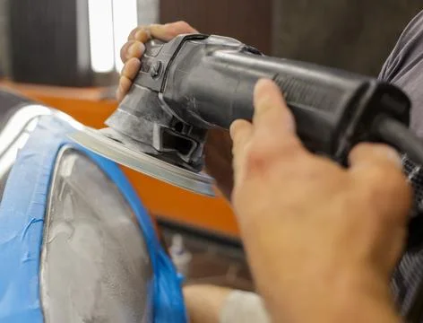 The process of polishing the headlights. Stock Photos
