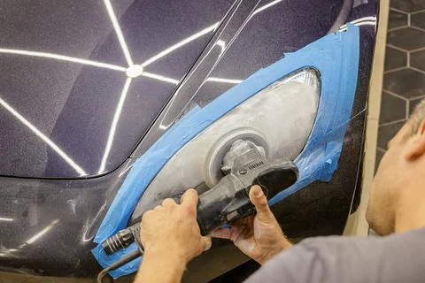 The process of polishing the headlights. Stock Photos