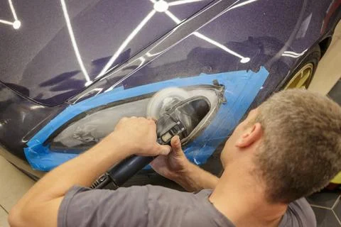 The process of polishing the headlights. Stock Photos
