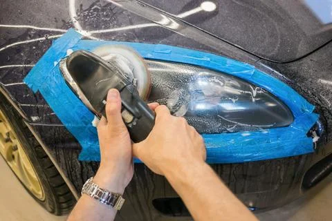 The process of polishing the headlights. Stock Photos
