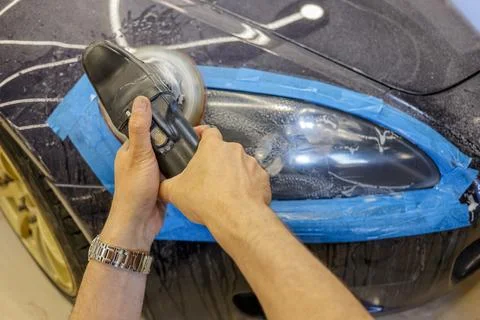 The process of polishing the headlights. Stock Photos