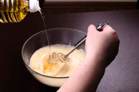 The process of pouring, adding vegetable oil to the dough for the preparation Stock Photos