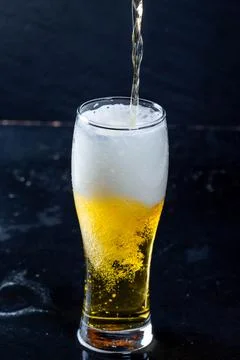 The process of pouring beer into a glass Stock Photos