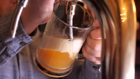 Process of pouring beer from tap into a glass. Man pours beer in a bar close-up. Stock Footage 145814809