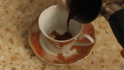 The process of pouring coffee into a coffee cup. Stock Footage 148998215