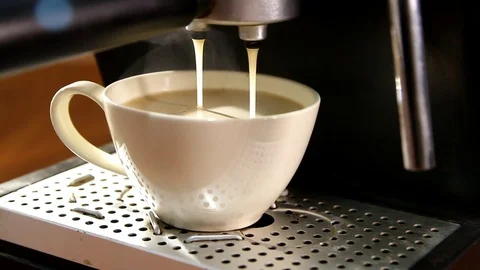 Process of pouring coffee into a white cup from a coffee machine Stock Footage 83096165