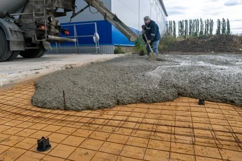 The process of pouring concrete on a prepared base made of sand Stock Photos