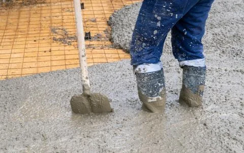 The process of pouring concrete on a prepared base made of sand Stock Photos