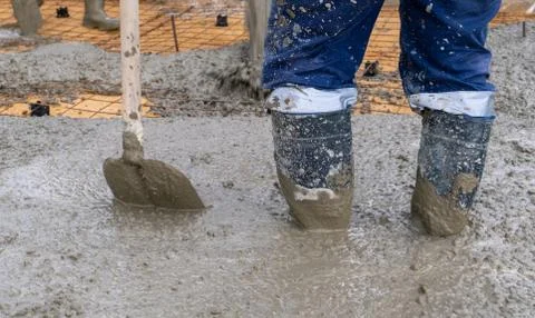 The process of pouring concrete on a prepared base made of sand Stock Photos