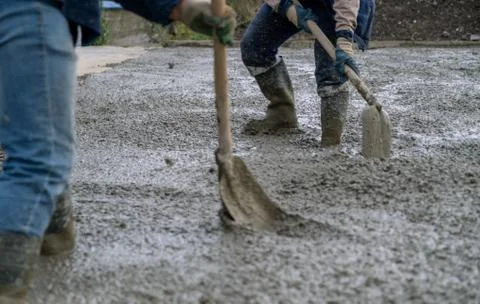 The process of pouring concrete on a prepared base made of sand Stock Photos
