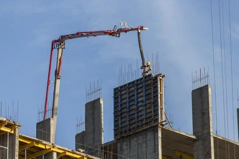 The process of pouring concrete into a structure. Stock Photos