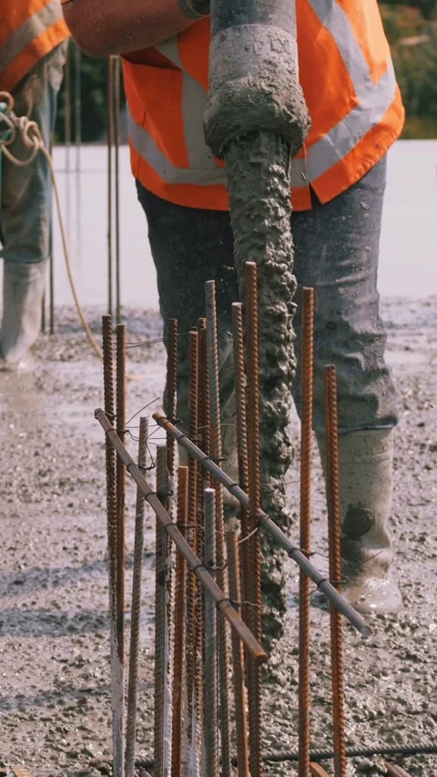 The process of pouring concrete takes place on a construction site, requiring Stock Footage 305406173