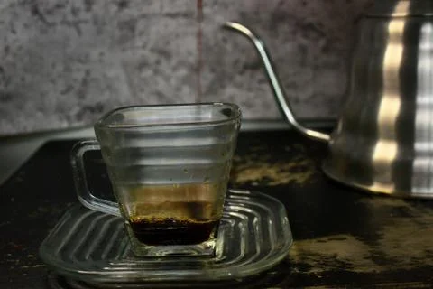 The process of pouring espresso produced mocha pot into a square-shaped coffe Stock Photos