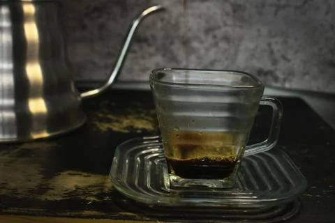 The process of pouring espresso produced mocha pot into a square-shaped coffe Stock Photos