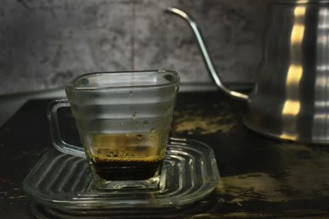 The process of pouring espresso produced mocha pot into a square-shaped coffe Stock Photos