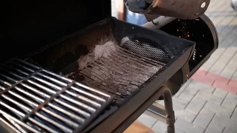 The process of pouring hot coals into the grill. A beautiful scattering of sp Stock Footage 156344402