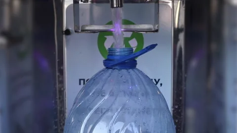 The process of pouring water into a vending machine for drinking ionized pure Stock Footage 149485734