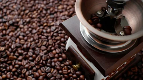The process of pouring whole coffee beans into the manual grinder. A scatteri Stock Footage 156210028