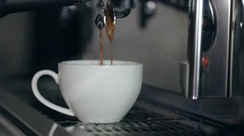 The process of preparation of cappuccino. Coffee is poured into a white cup. 스톡 동영상 66557493
