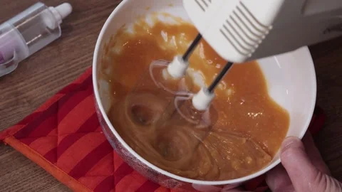 Process of preparation of caramel cream. Beating caramel, egg white and butter Stock Footage 287277443
