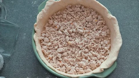 Process preparation of meat pie crust filled with a crumb mixture in a pie dish Stock Footage 339094496