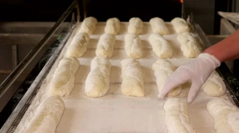 Process of preparing baguettes to place in the oven for baking Stock Footage 64470726