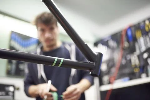 Process of preparing a bike frame with masking tape for a custom painting d.. Stock Photos