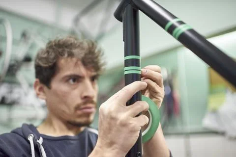 Process of preparing a bike frame with masking tape for a custom painting d.. Stock Photos