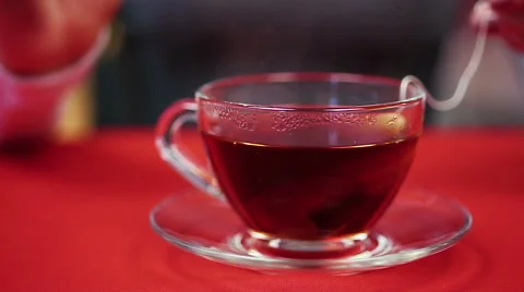 Process of preparing black tea. Woman pressing teabag with the help of spoon Stock Footage 62364778